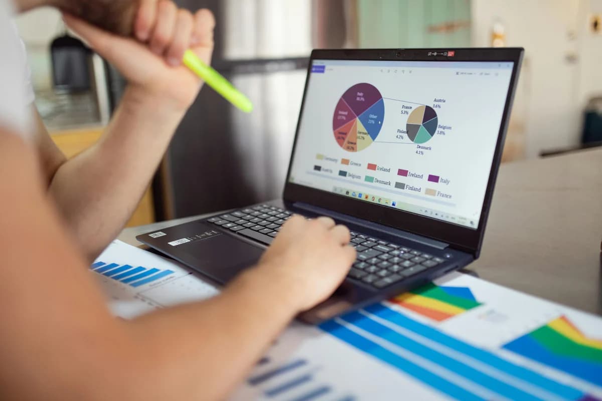A creator reviewing revenue charts on a laptop